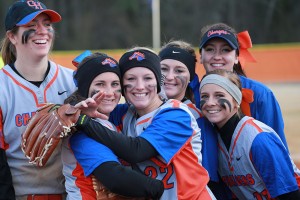 female softball teammates smiling after a win