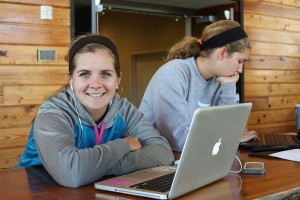 student with laptop smiling