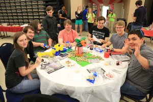 students engaged in an activity around a table