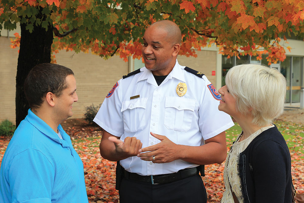 Campus Safety officer talking with two students