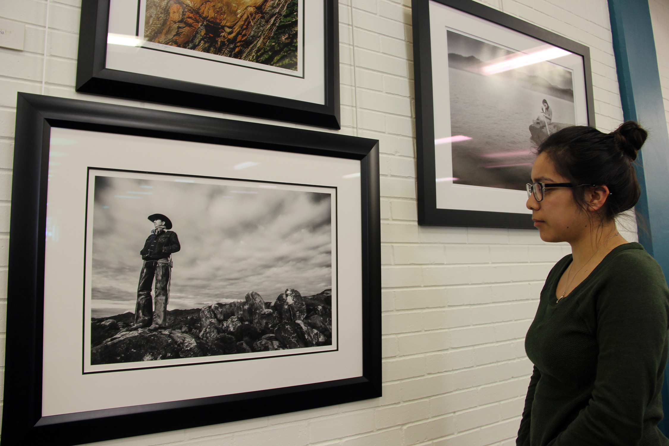 student looking at art on wall