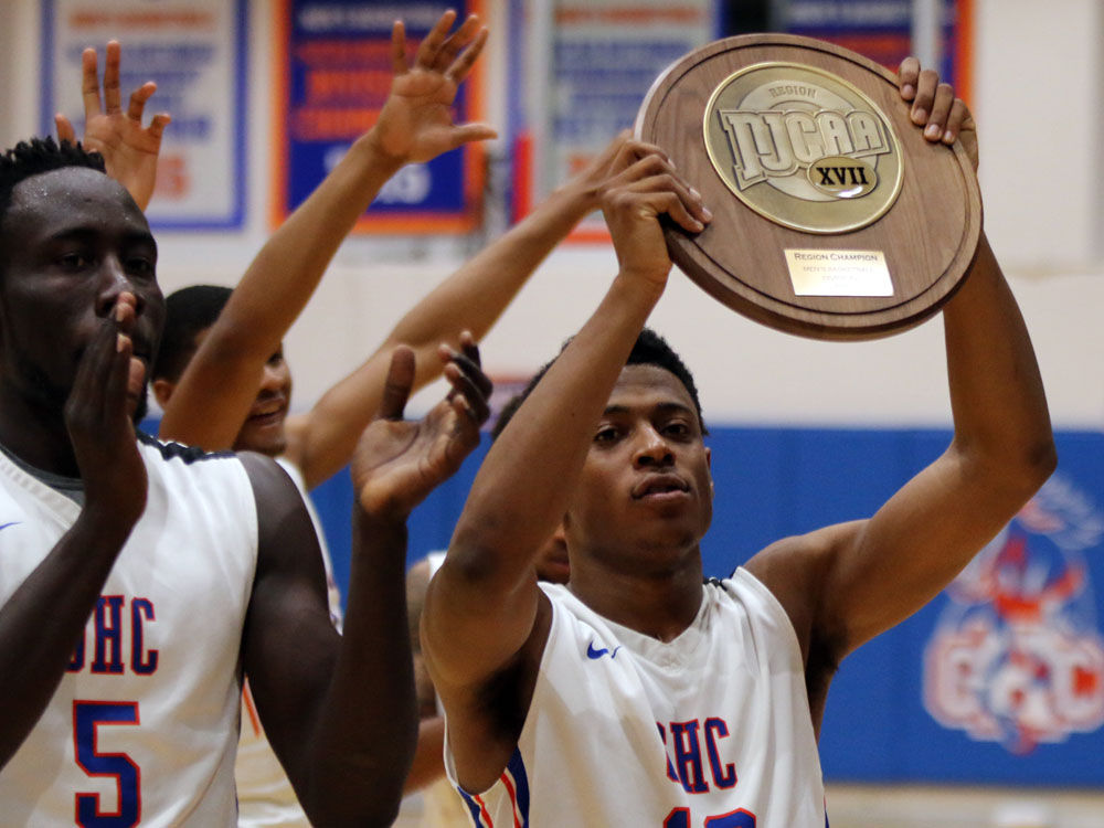 basketball team holds up trophy