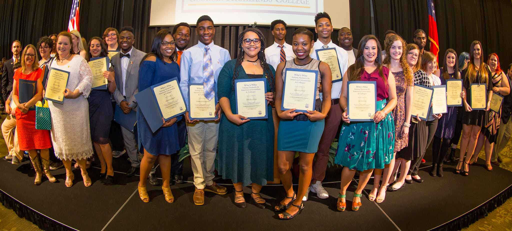 students holding awards