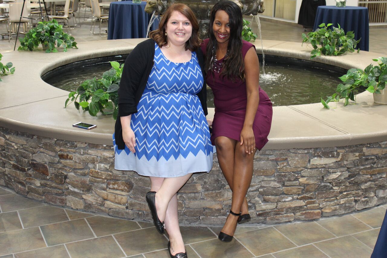 two ladies sitting by fountain