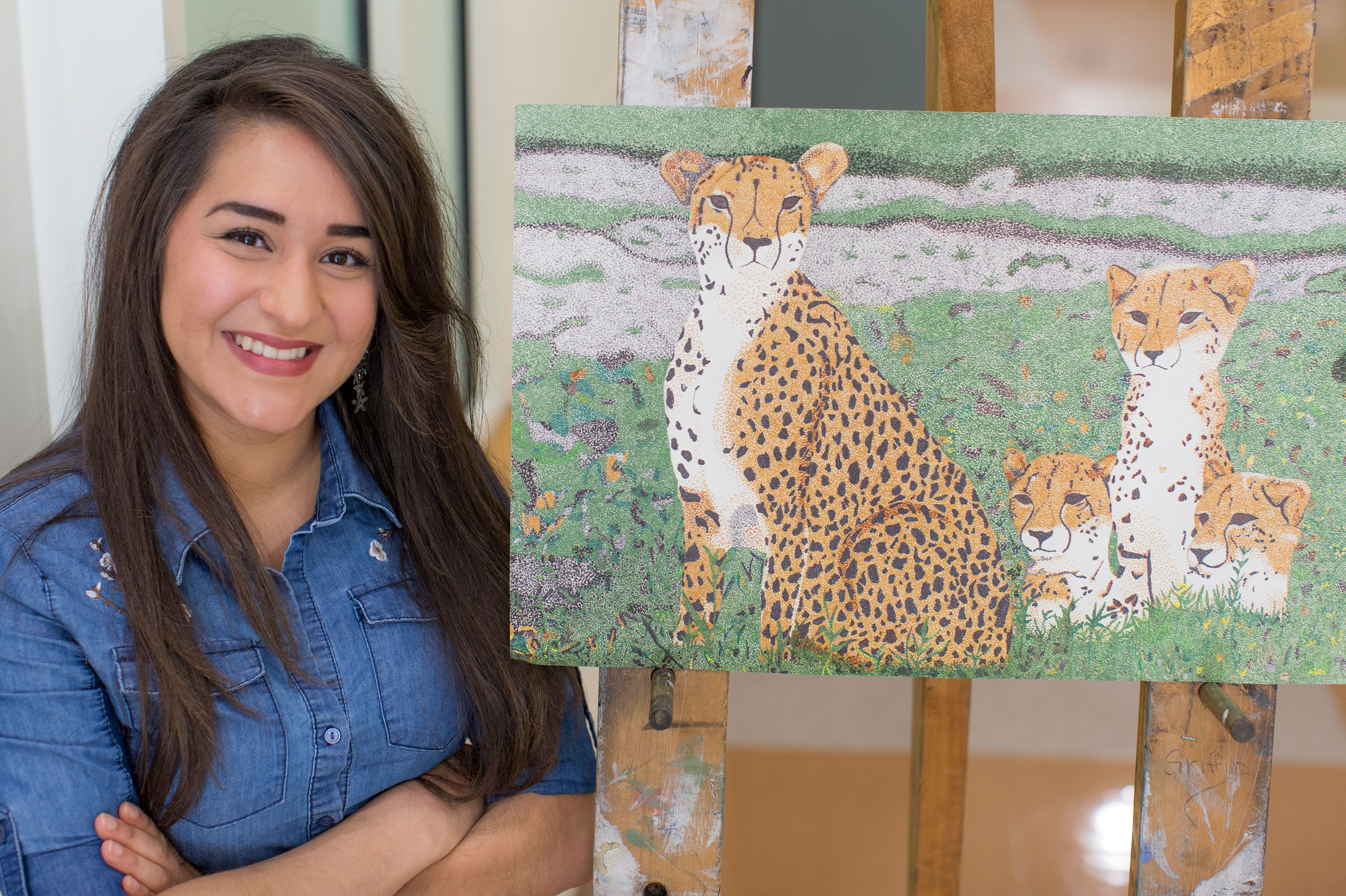 student standing next to painting