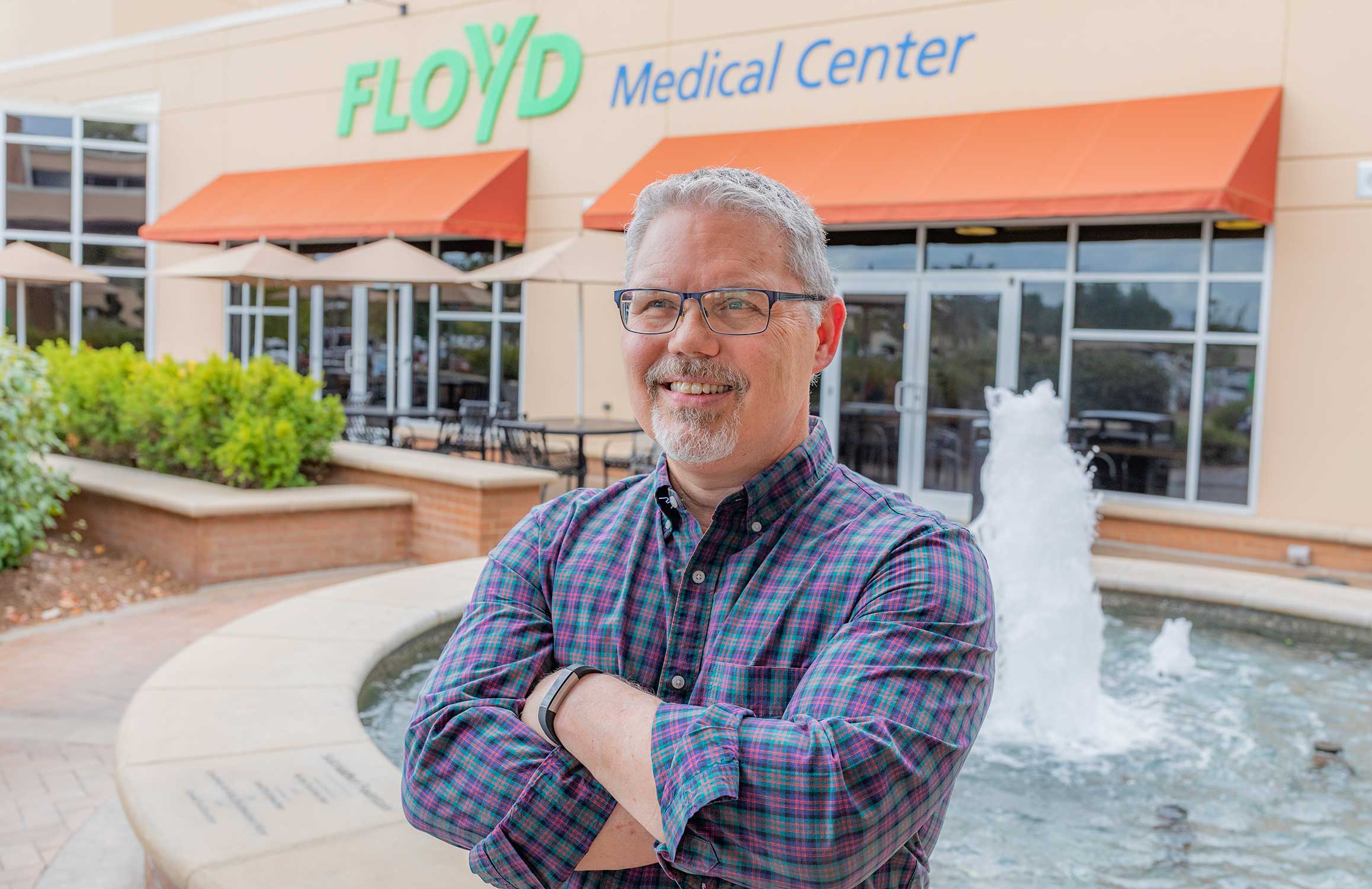 bill posing in front of the hospital