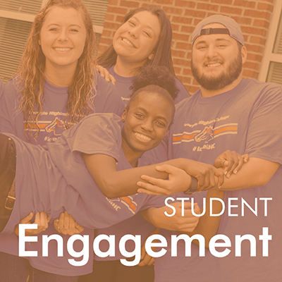 Student Engagement - Students smiling and holding up a fellow student with orange color cast