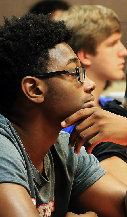 Student observing lecture in classroom